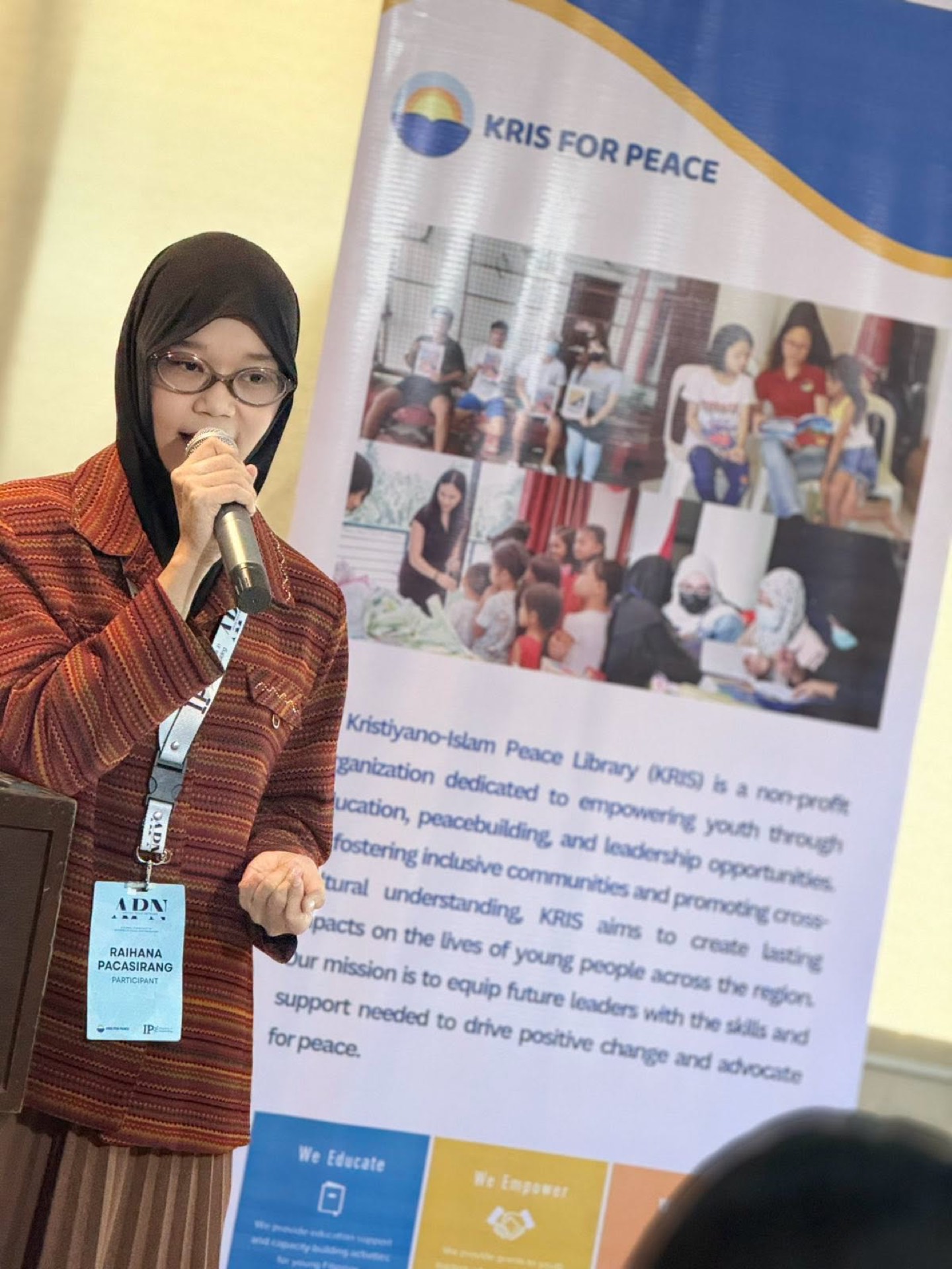 An APN participant presents at the Champions for Peace roll-up banner, Philippines.