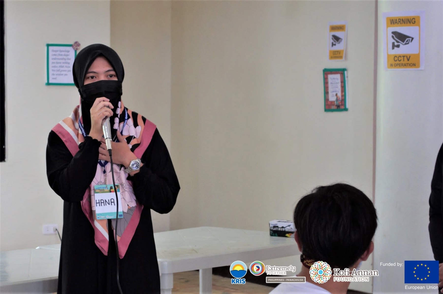 A participant shares her thoughts with the group at the microphone.