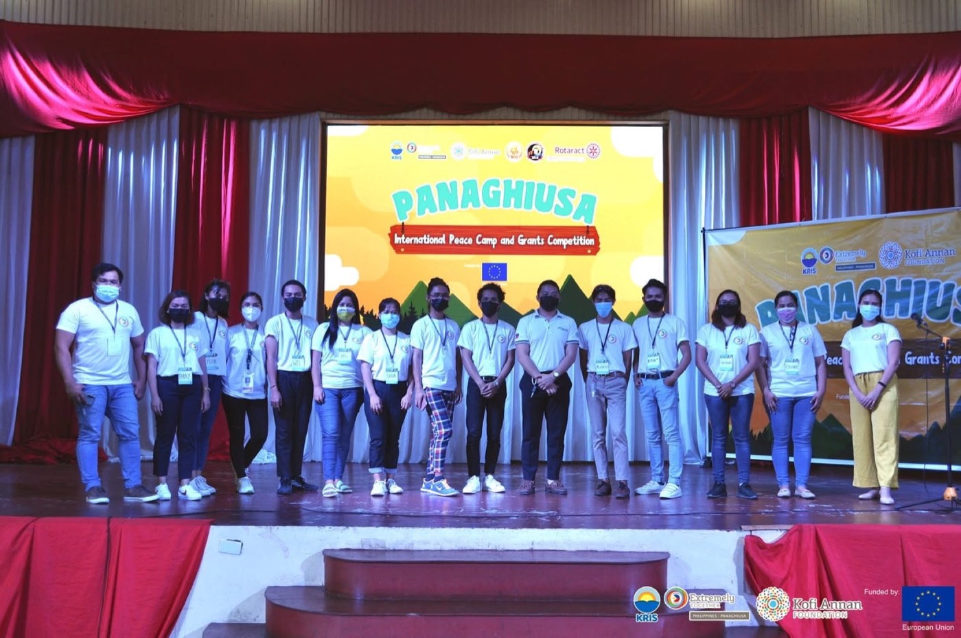 The organizing team and facilitators pose on stage.