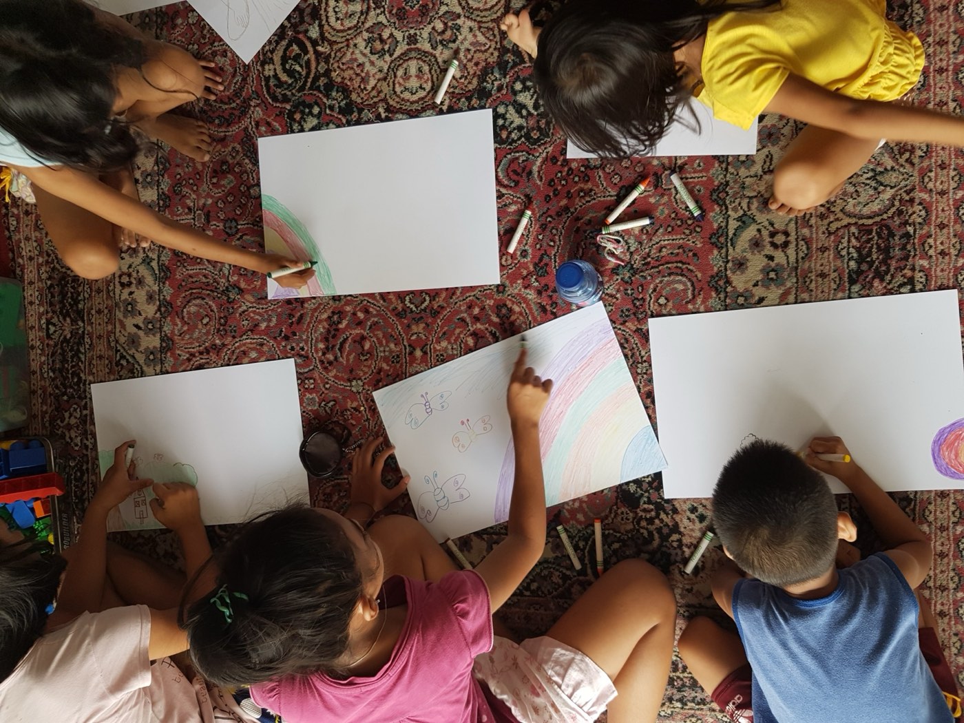 Children draw and color together at a KRIS scholarship activity.