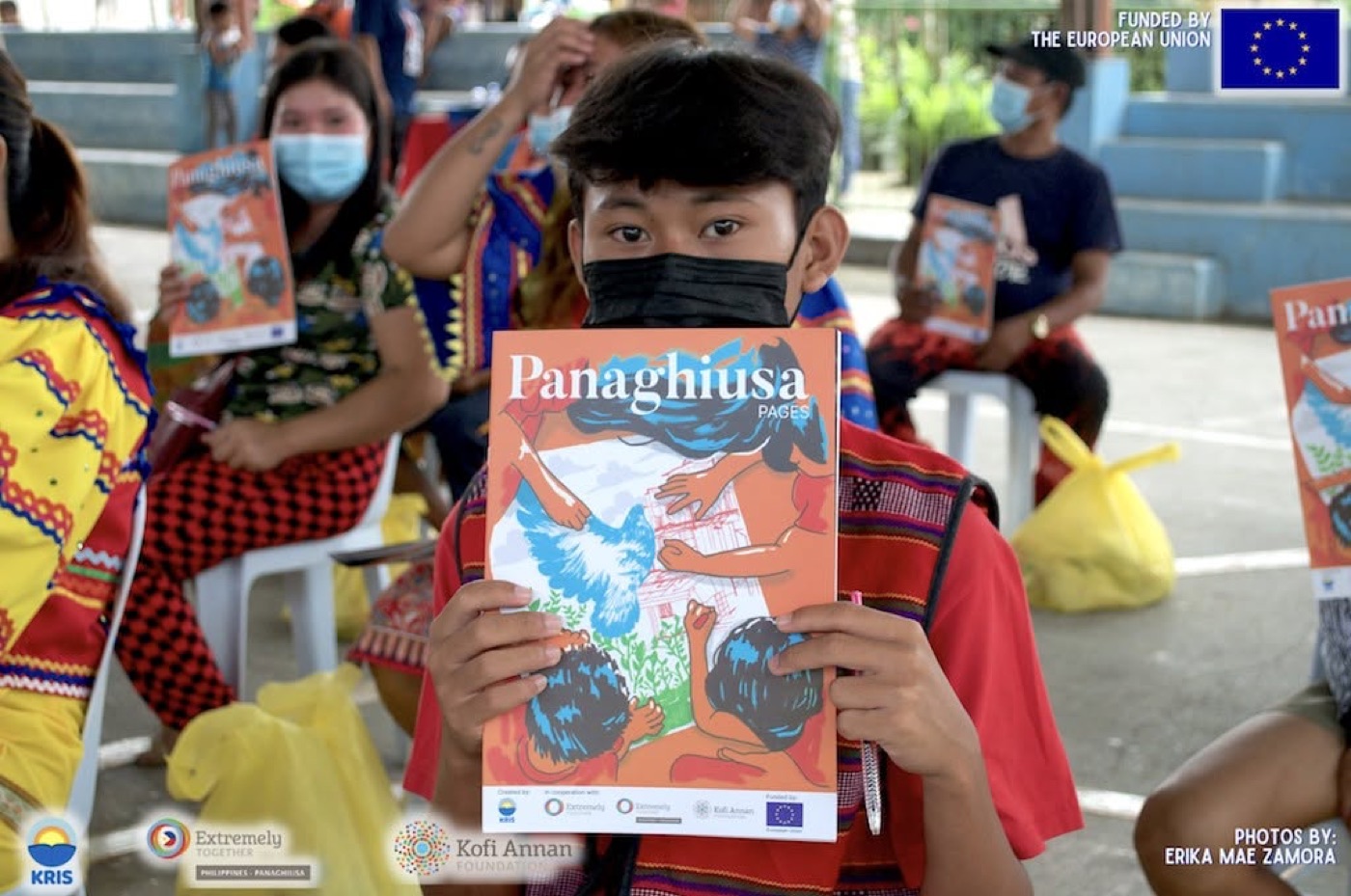 A young participant holds up a copy of the Panaghiusa Pages magazine.