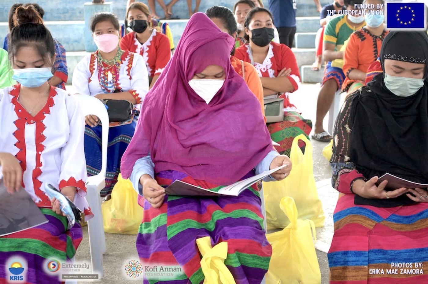 Community members read a copy of the Panaghiusa Pages magazine.